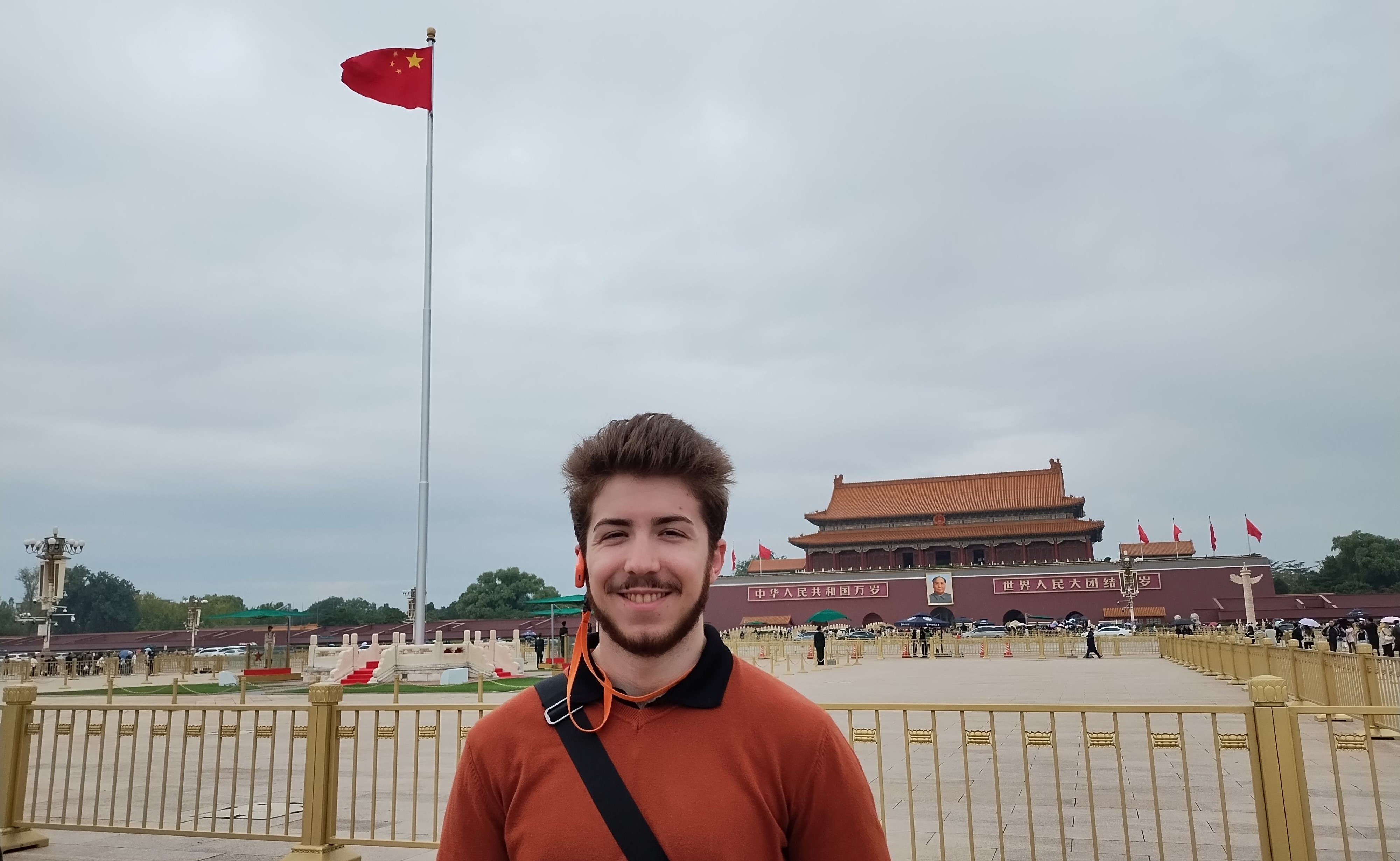 graduate assistant standing in front of China forbidden city